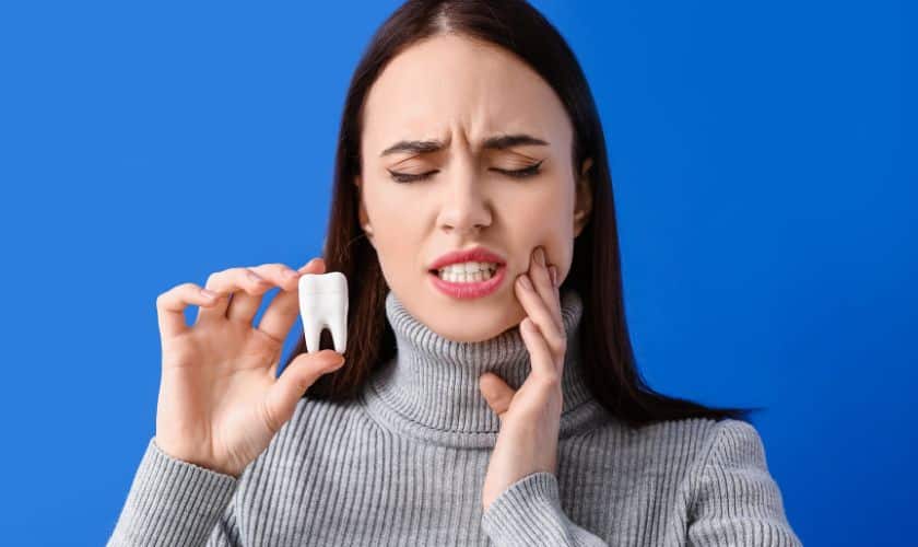A woman facing tooth pain showing dental emergency